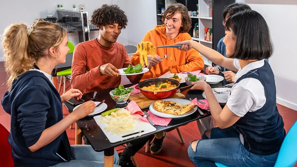 Students cooking together in a shared kitchen in Melbourne.